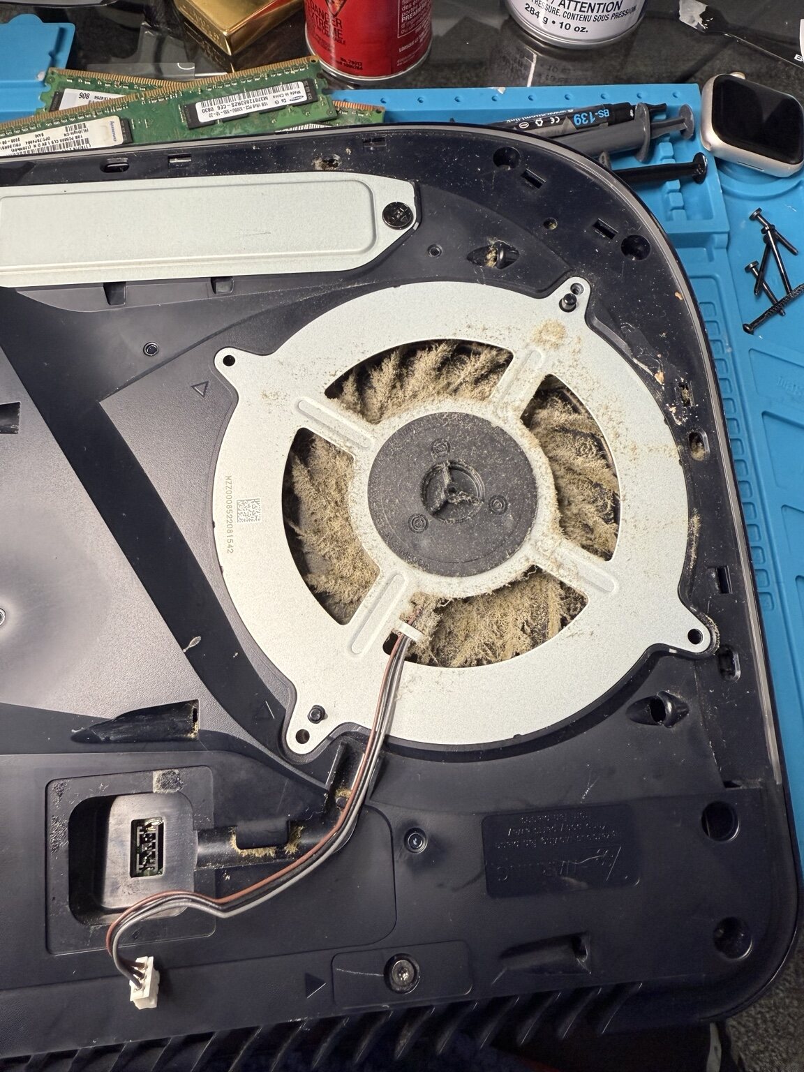 Dust-packed PS5 cooling fan removed for service