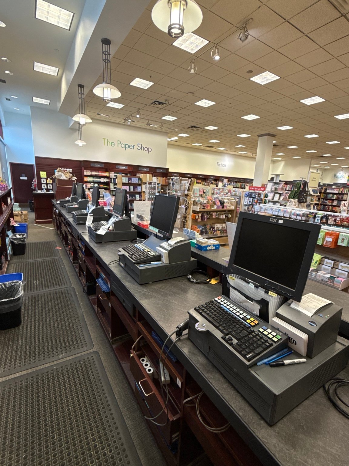 Multiple POS checkout terminals and peripherals along a retail counter