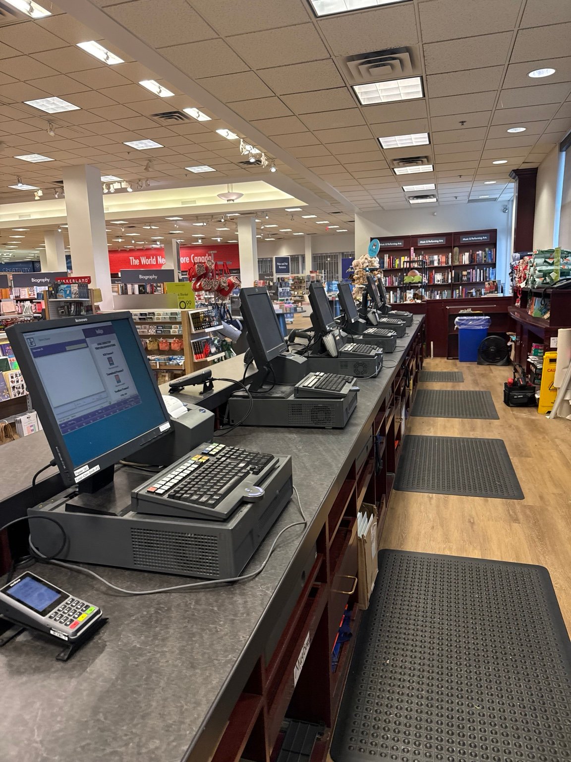 Retail checkout row showing POS terminals, cash drawers and payment peripherals