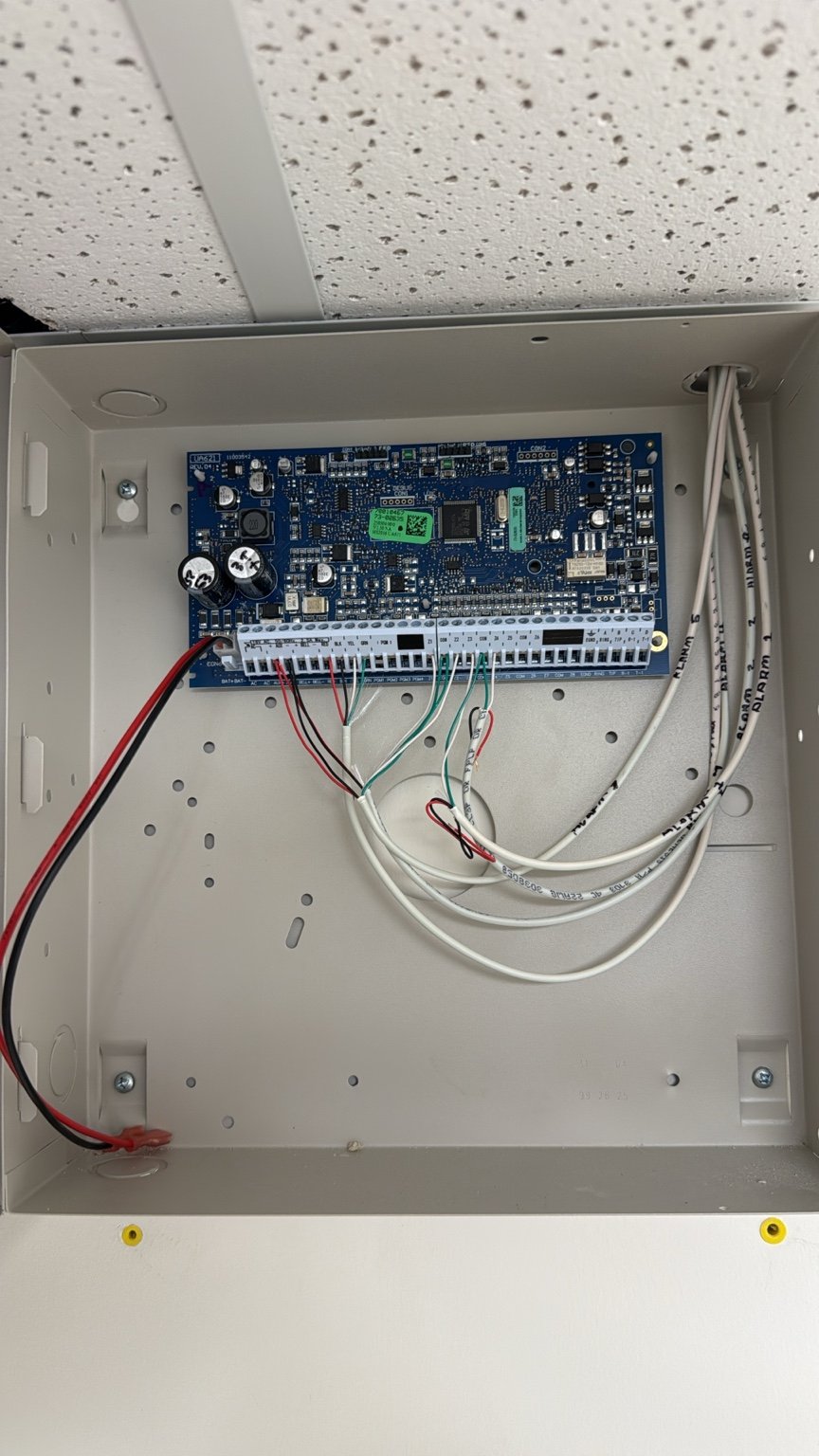 Wall-mounted security control enclosure with circuit board and cable terminations