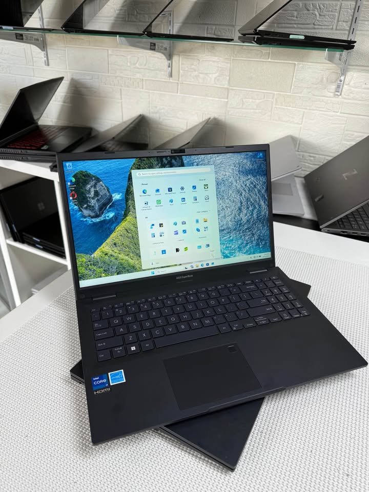 ASUS ExpertBook laptop with Intel Core i7 open on a table showing Windows 11