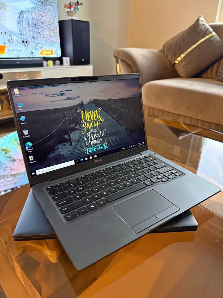 Black Dell Latitude 7400 14-inch laptop open on a glass table