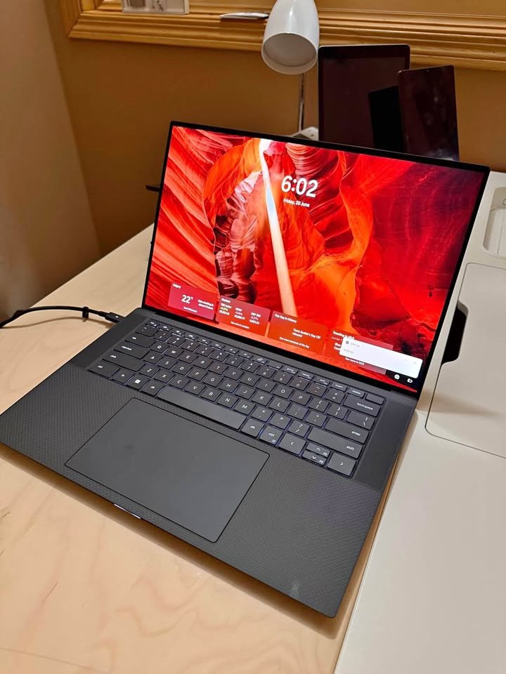 Dell Precision 5560 15.6-inch laptop open on a desk showing the lock screen