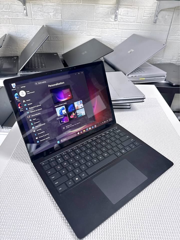 Black Microsoft Surface Laptop 4 open showing Windows 11 settings