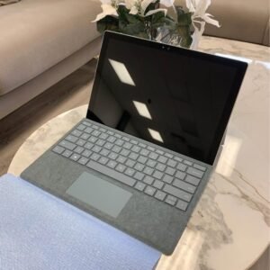 Microsoft Surface Pro 5 with grey keyboard cover on a marble table
