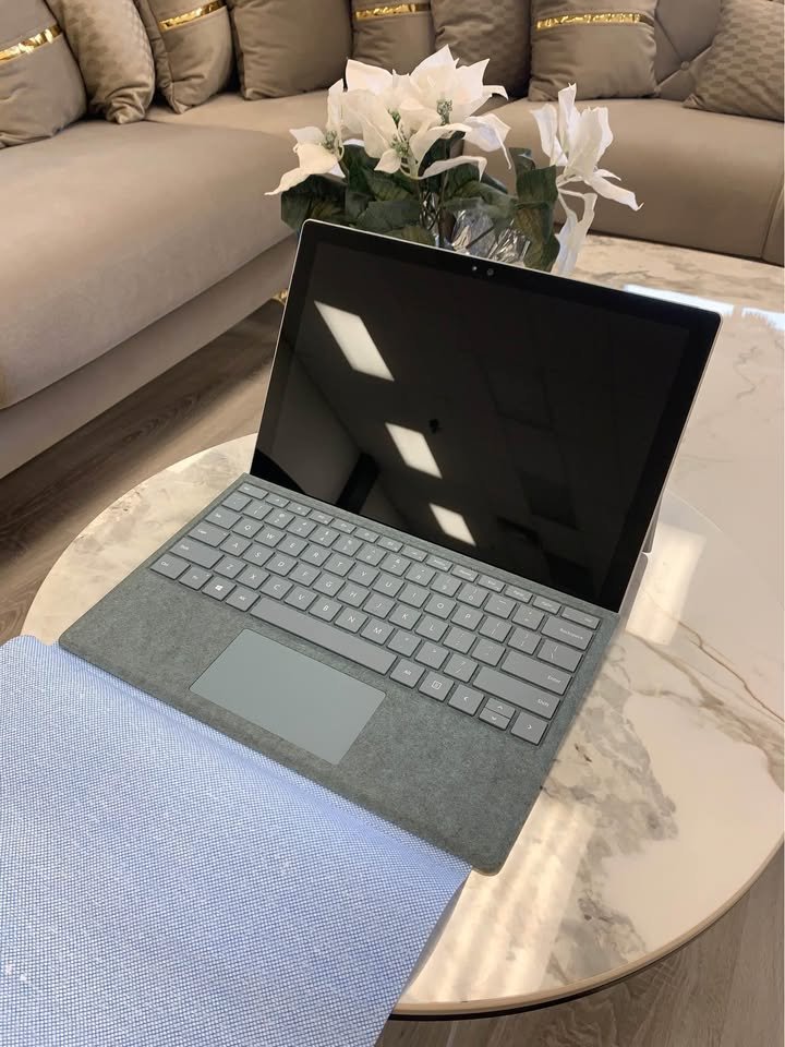 Microsoft Surface Pro 5 with grey keyboard cover on a marble table